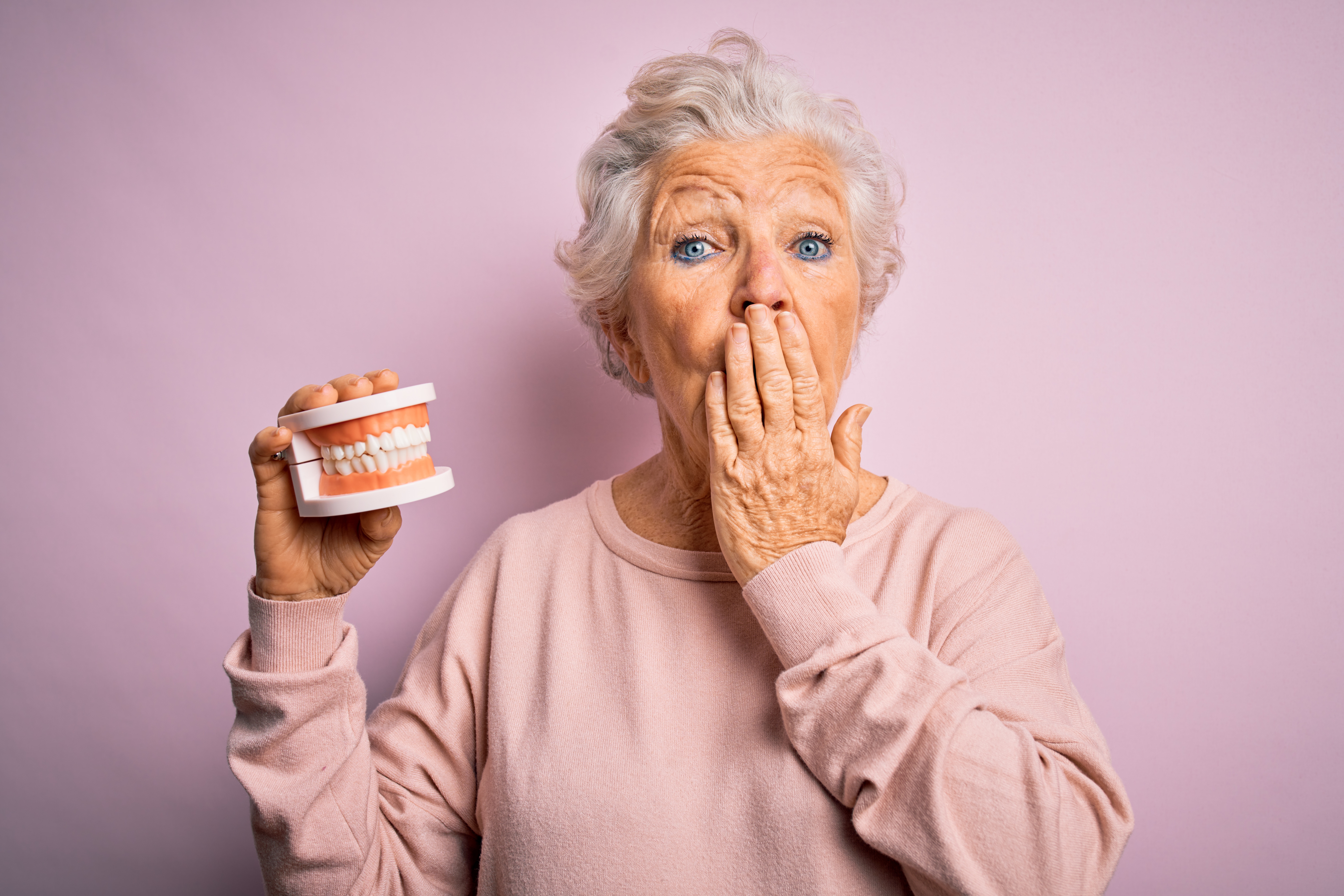 Shocked senior woman with dentures