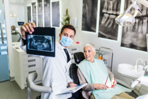 Dentist showing elderly woman x-ray results
